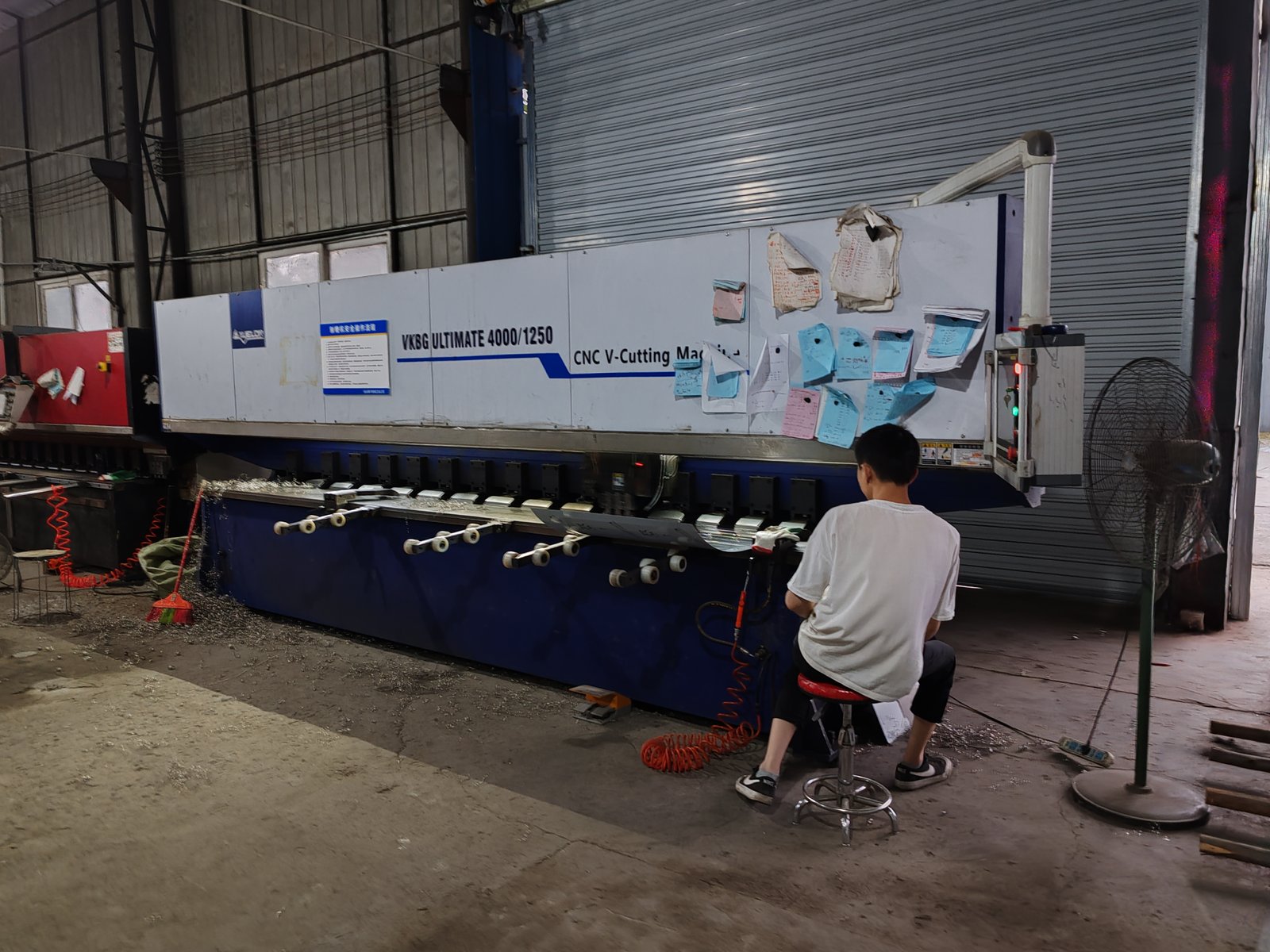 CNC V-grooving machine processing a custom stainless steel sheet metal part
