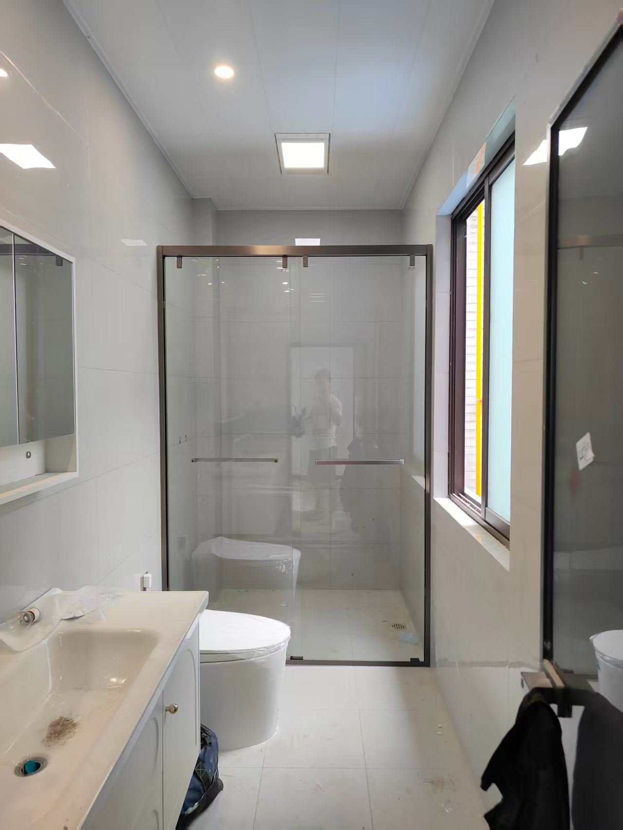Bronze framed sliding shower enclosure showing slim door profiles and top rail