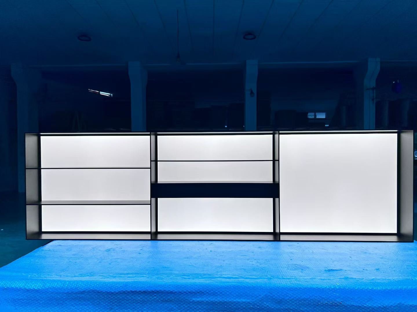 Wide custom metal display counter with integrated white lighting