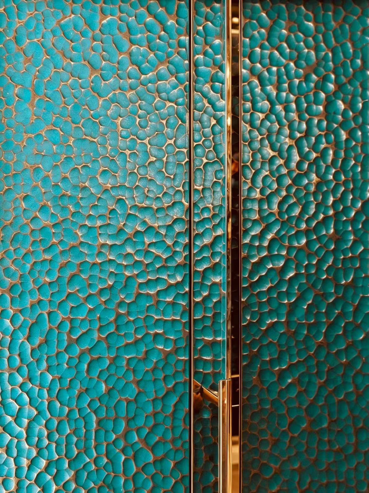 Close view of a hammered turquoise surface with polished trim